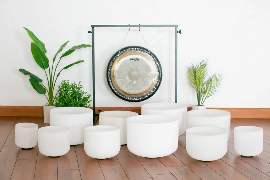 Crystal singing bowls held during a sound healing ceremony in Ibiza